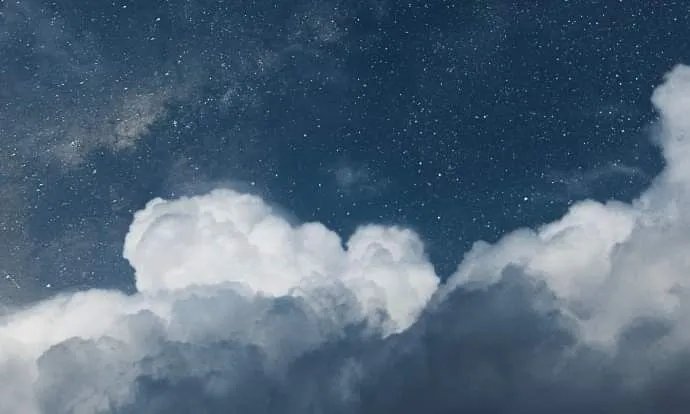 A night sky full of stars above the clouds